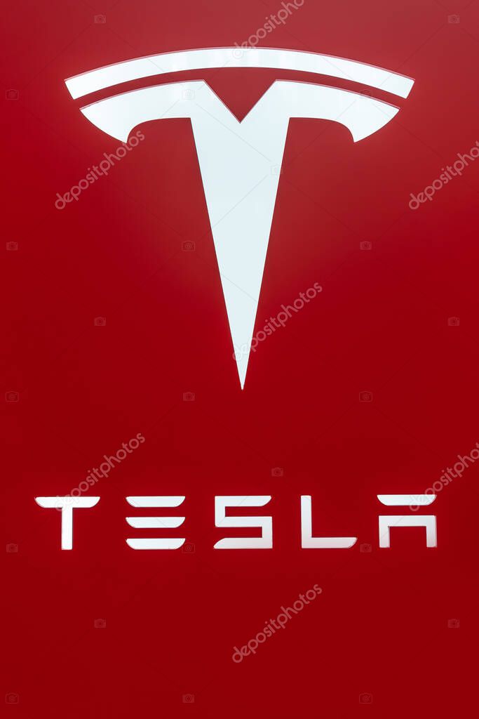 KL ,Malaysia - July 3,2023 : Tesla's logo and brand name on the red background.