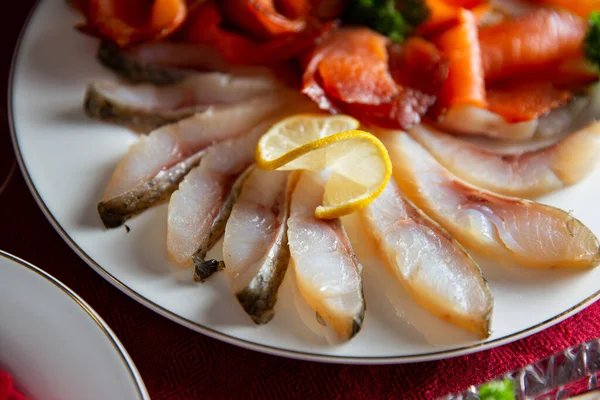 Festive fish table with Cold Smoked Salmon, Cold Smoked Whitefish and Cold Smoked Pike - traditional celebration delicacies in Finland and Scandinavia