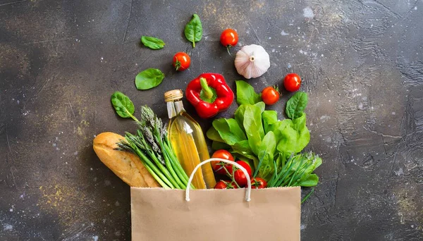 Delivery healthy food background. Healthy vegan vegetarian food in paper bag vegetables and fruits on white, copy space, banner. Shopping food supermarket and clean vegan eating.