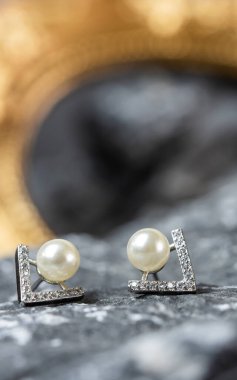 A beautiful Pearl Ear studs. Close-up of white pearl earrings.