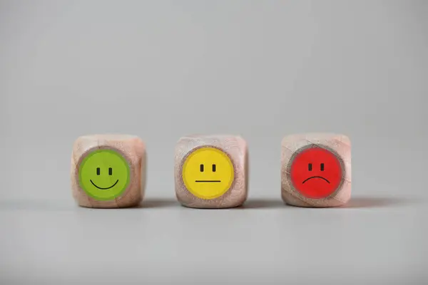Image of emotions on Choosing a positive wooden blocks. Joy, calm, anger. Mental health and emotional state concept