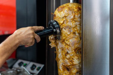 Kebap lokantası, şef ızgaradaki eti kesmek için elektrikli alet kullanır.