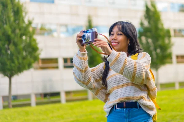 Asian young woman photography with a vintage photo camera, enjoying photography
