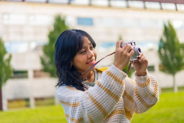 Asian young woman photography with a vintage photo camera, visiting the city and taking photos