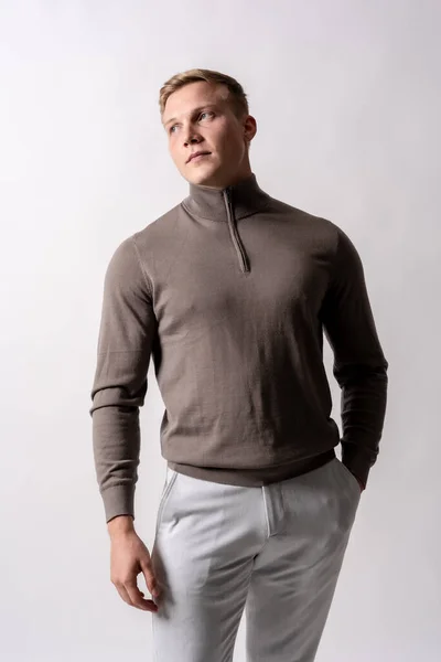 stock image Portrait of an attractive blond german model with brown sweater on a white background, vertical photo