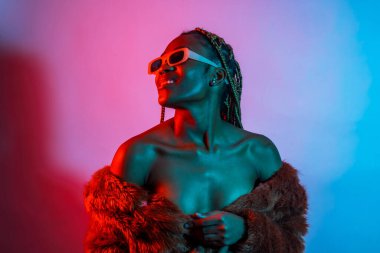 Attractive black ethnic woman with braids with red and blue led lights, trap dancer wearing sunglasses clipart