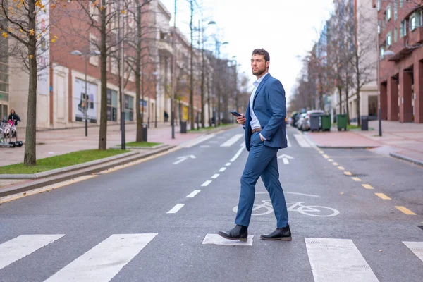 Businessman or finance man crossing a zebra crossing heading to the office
