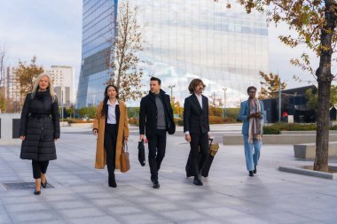 Group of multi-ethnic business people, business park, coworkers, walking to work