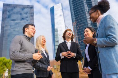 Middle-aged multi-ethnic businessmen and businesswomen, business park, talking to each other