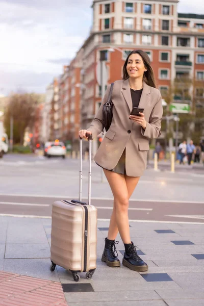 Tourist woman with suitcase on vacation in the city just arrived by train