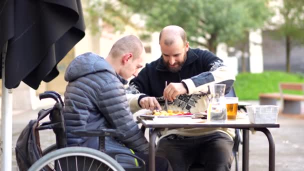 Disabled Person Eating Terrace Restaurant Friend Helping Him Eat — Stock Video