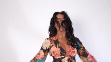 Mulatto woman dancing on a white background, Cuban traditional dance