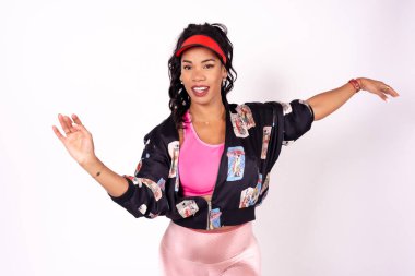Portrait of black ethnic woman dancing on a white background, samba, cuban traditional dance, urban outfit