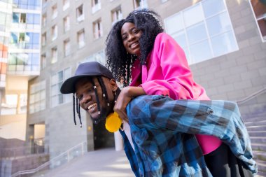 Young African American women in the city, lifestyle of friends, portrait on top of the guy