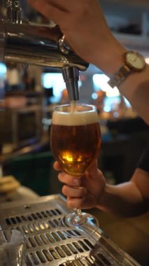 A waitress putting a beer in the bar or restaurant