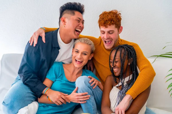 stock image Lgtb couples of gay boys and girls lesbian in a portrait on a sofa at a house party, having fun