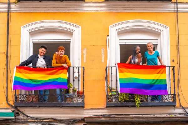 在一个家庭派对上 男同性恋和女同性恋者的夫妇在阳台上挂着Lgtb国旗 — 图库照片