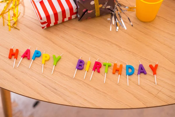 stock image Happy birthday lettering on the table at a friends birthday party with gifts