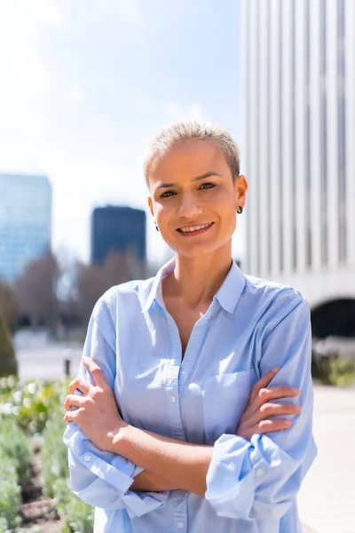 Empowered woman businesswoman in a business area looking at camera, executive portrait