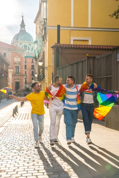 几个男人带着彩虹旗 在城市里举行同志骄傲派对 享受着游行的乐趣 — 图库照片