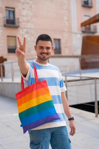 城市里带着彩虹大包小包的同性恋男子的画像 骄傲派对和同性恋 — 图库照片