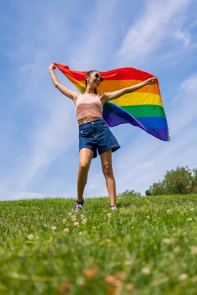 Caucasian Brunette Woman Rainbow Lgbt Flag Grass Blue Sky Background — Stock Photo, Image