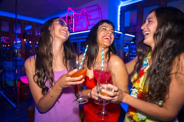 stock image Portrait attractive women toasting and having fun with drinks in disco club at summer night party in pub