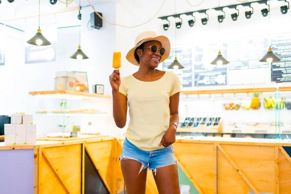 Αφρικανική Μαύρη Εθνικότητα Γυναίκα Τρώει Ένα Παγωτό Μάνγκο Ένα Κατάστημα — Φωτογραφία Αρχείου