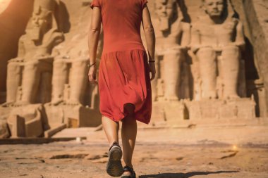 Kırmızı elbiseli genç bir turist Nubia 'daki Abu Simbel Tapınağı' na giriyor Nasser Gölü 'nün yanındaki. Firavun 2. Ramses Tapınağı