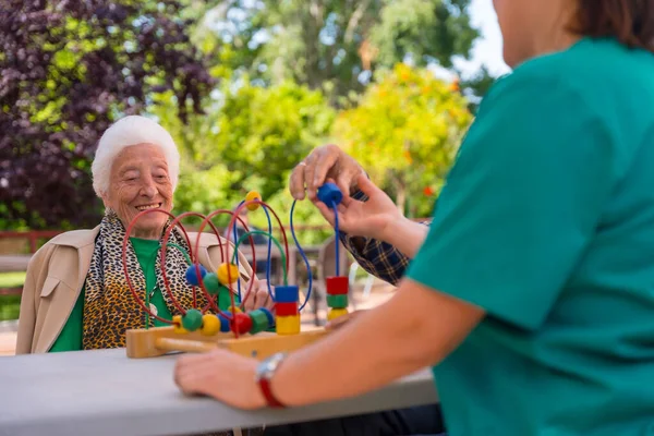 Hands Two Elderly People Garden Nursing Home Retirement Home Playing — Stock Photo, Image