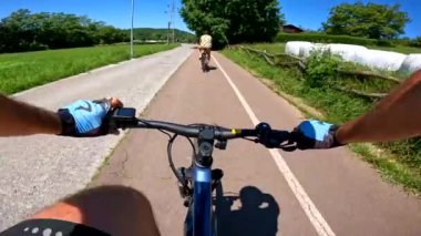 first-person view of a mountain bike on a greenway bike trail with a friend