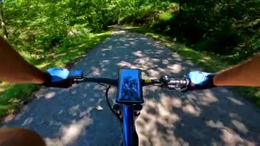 first person view of mountain bike on a path next to a river