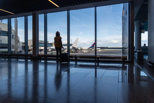 Vrouwelijke Passagier Met Een Koffer Luchthaventerminal Kijkend Naar Vliegtuigen Die — Stockfoto
