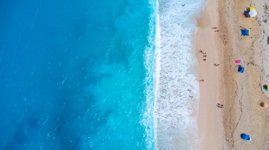 Aerial drone aerial shot in summer on paradise sandy beach Megali Petra in Lefkada. Beautiful crystal clear turquoise and blue waters. Greece clipart