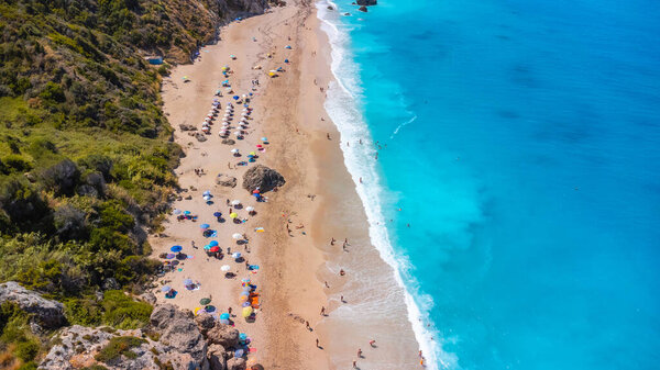 Aerial view from drone on the beautiful clear turquoise and blue water on the sandy Megali Petra beach in Lefkada. Greece