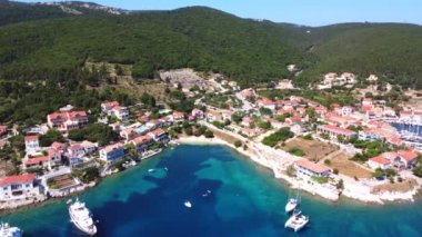 Yunanistan 'ın Kefalonia adasındaki Fiskardo köyünün limanındaki küçük bir plajın yazın havadan görünüşü