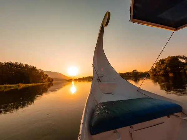 Sunset sailing on the lake in a traditional boat on a sightseeing excursion from Shkoder in Shiroka. Albania