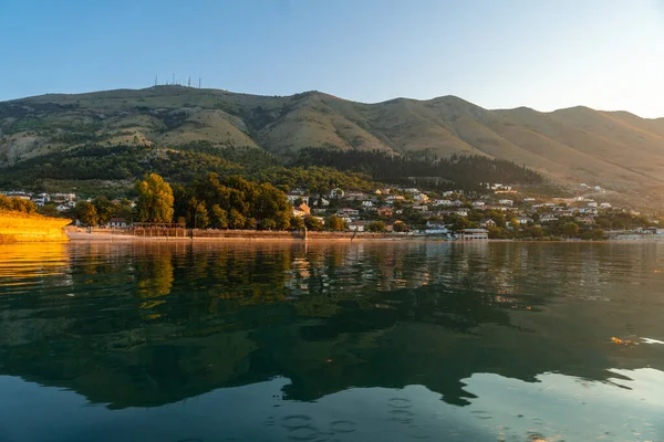 View of the city of Shiroka from the lake at sunset on a traditional boat on a sightseeing excursion from Shkoder. Albania