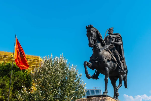 The beautiful Skanderbeg horse monument in Skanderbeg Square in Tirana and the red flag of Albania