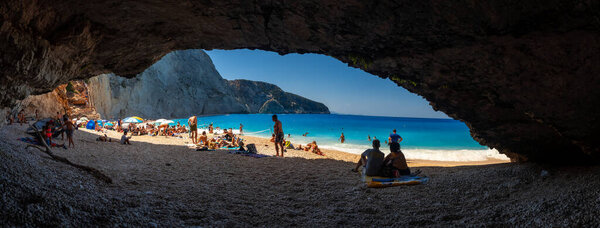 Bathers on Porto Katsiki beach on Lefkada island from a small cave, Greece
