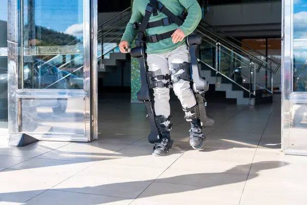 Mechanical exoskeleton, disabled person walking with the help of robotic skeleton, physiotherapy in a modern hospital, futuristic physiotherapy