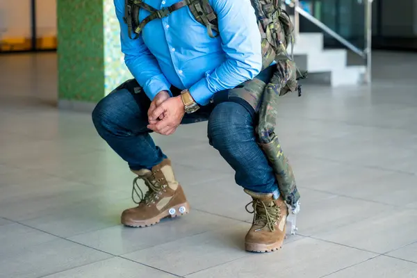 Mechanical military exoskeleton to help unrecognizable soldiers and military personnel in their work, crouched back pose. Camouflage exoskeleton for futuristic high security