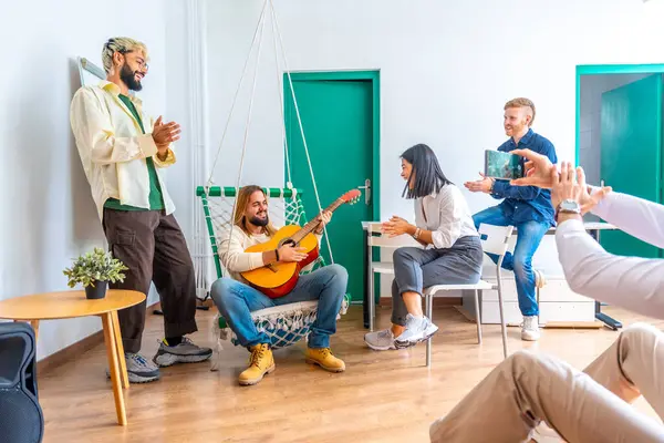 People singing and playing the guitar during a break in a coworking