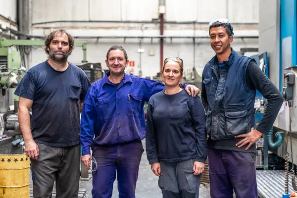 Portrait of a team of workers from the metal industrial factory trade in the numerical control sector talking