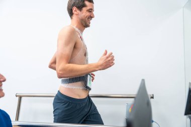 Adam hastanede kardiyovasküler stres testi yaparken koşuyor.