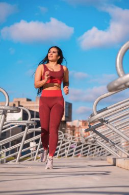 Şehir parkında koşan bir kadının dikey ön görüntüsü