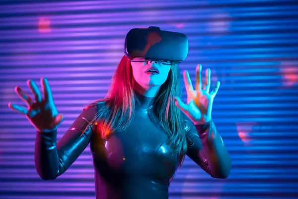 Gamer wearing augmented reality goggles in a futuristic space with neon lights