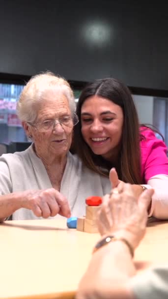 Nurse Helping Elder Woman Playing Skill Games Nursing Home — Stock Video