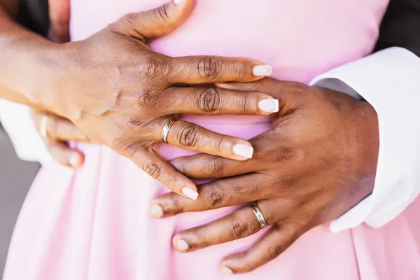 Black ethnic wedding couple with rings at a beautiful wedding, marriage ceremony