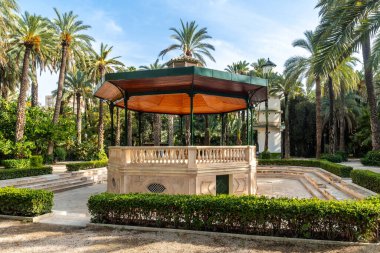 Quisco in the temple or pergola in the palm grove park in the city of Elche. Spain clipart